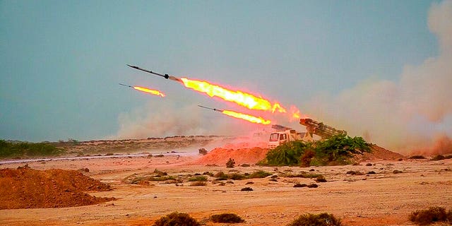 Missiles are fired in a Revolutionary Guard military exercise. Iran's paramilitary Revolutionary Guard fired a missile from a helicopter targeting the mock-up aircraft carrier in the strategic Strait of Hormuz. (Sepahnews via AP)