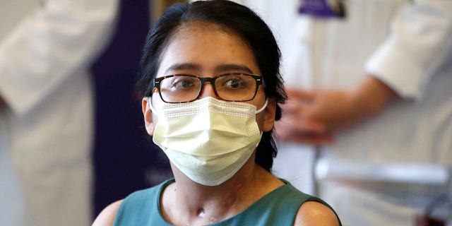 Mayra Ramirez, a COVID-19 survivor due to a double-lung transplant, listens Thursday, July 30, 2020, to a question about her journey through the pandemic during her first news conference at Northwestern Memorial Hospital in Chicago. Ramirez is the first known patient in the United States who received double-lung transplants due to COVID-19. (AP Photo/Charles Rex Arbogast)