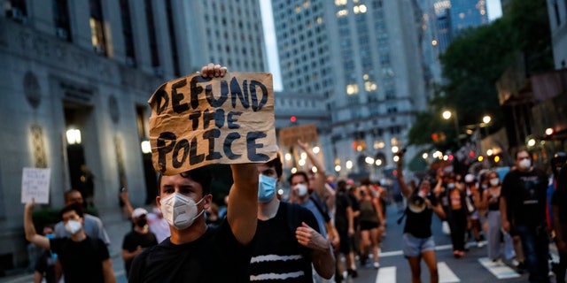 New York Times op-ed blasts petition to eliminate standardized tests in order to combat racism 4 A demonstrator holds a sign that reads