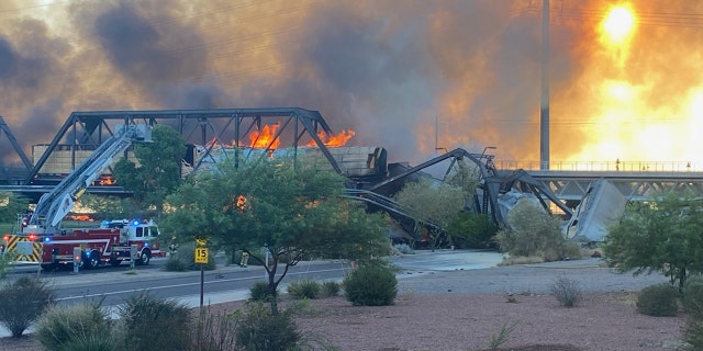 A train bridge partially collapsed after a derailment and fire in Tempe, Ariz. on July 29, 2020.