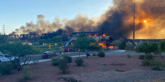A train bridge partially collapsed after a derailment and fire in Tempe, Ariz. on July 29, 2020.