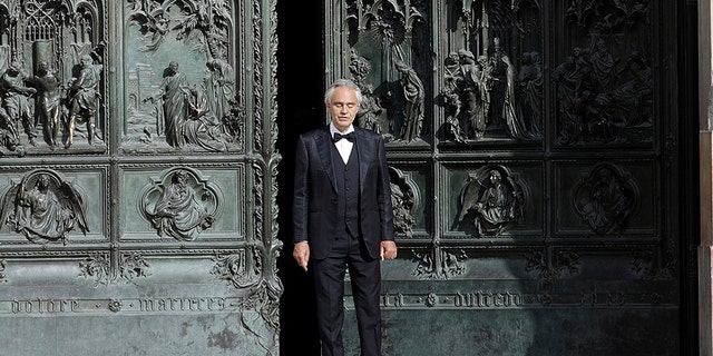 FILE - In this Sunday, April 12, 2020, Italian singer Andrea Bocelli performs outside the Duomo cathedral, in Milan, Italy. (AP Photo/Luca Bruno, File)