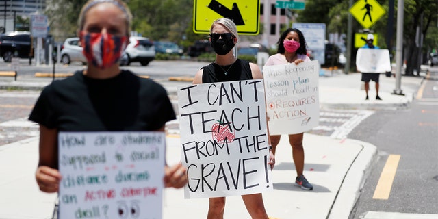 Middle school teacher Brittany Myers (center) stands in protest on July 16, 2020 in front of the District Office of Hillsborough County Schools, in Tampa, Fla.  Teachers and administrators of Hillsborough County Schools rallied against the reopening of schools due to health and safety concerns.  COVID-19 among epidemics.  (Octavio Jones / Getty Image)