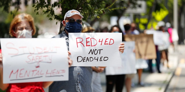 TAMPA, FL - JULY 16: Middle school teacher Scott Hottenstein stand in protest in front of the Hillsborough County Schools District Office on July 16, 2020 in Tampa, Florida. Teachers and administrators from Hillsborough County Schools rallied against the reopening of schools due to health and safety concerns amid the COVID-19 pandemic. (Photo by Octavio Jones/Getty Images)