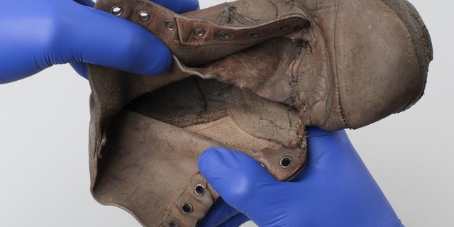 The shoe that belonged to six-year-old Holocaust victim Amos Steinberg. The inscription can be seen inside the show.