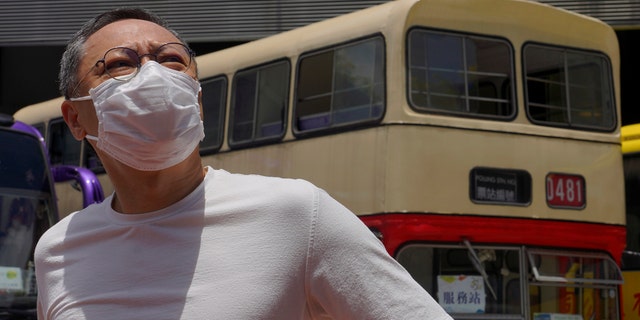 Occupy Central leader Benny Tai stands in front of a vintage double-deck bus used as a polling center for an unofficial "primary" for pro-democracy candidates ahead of legislative elections in Hong Kong on July 11. Tai, a professor and leading figure in Hong Kong's political opposition has been fired from his university job following China's passage of a sweeping new national security law. (AP Photo/Vincent Yu)