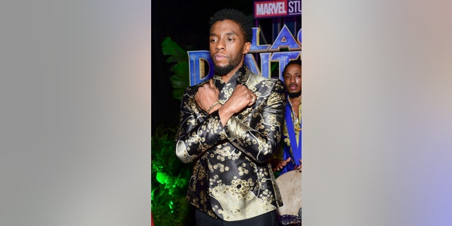 Chadwick Boseman, who plays the main character in "Black Panther," shows off the "Wakanda Forever" greeting.