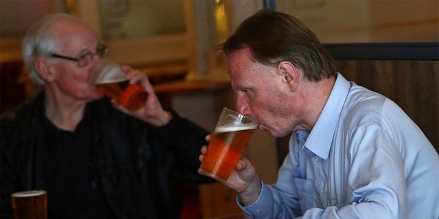 Customers drink beer at The Holland Tringham Wetherspoons pub after it reopened following the outbreak of the coronavirus disease (COVID-19), in London, Britain July 4, 2020. REUTERS/Hannah McKay - RC2AMH9ARMHE