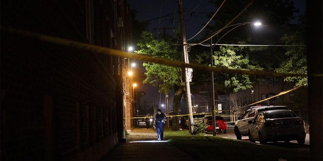Police work the scene where a 19-year-old man was shot in the 400 block of West 77th Street in Chicago on July 3, 2020. (Armando L. Sanchez/Chicago Tribune/Tribune News Service via Getty Images)