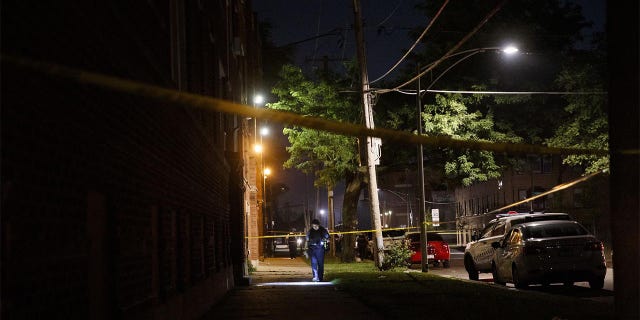 Police work the scene where a 19-year-old man was shot in the 400 block of West 77th Street in Chicago on July 3, 2020.