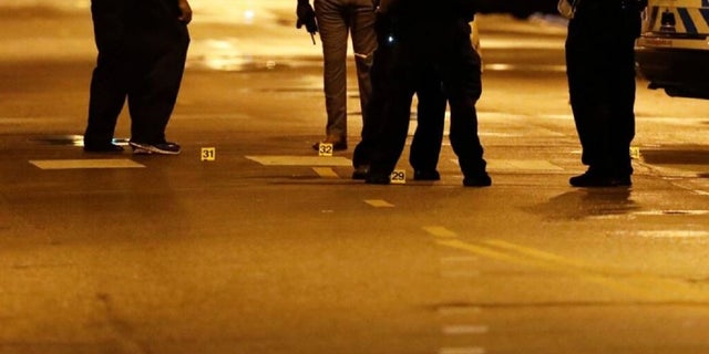 Evidence markers are seen on the ground as Chicago Police officers investigate the scene of a shooting in Chicago, Illinois, on July 21, 2020.(KAMIL KRZACZYNSKI/AFP via Getty Images)