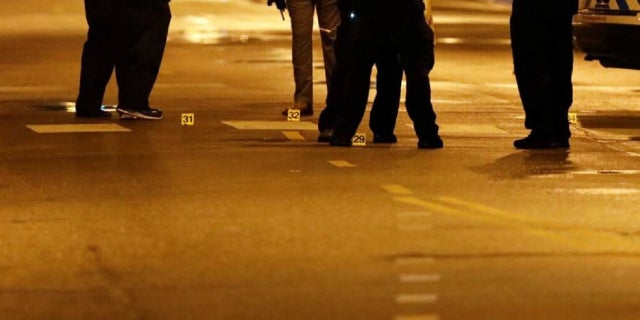 Evidence markers are seen on the ground as Chicago Police officers investigate the scene of a shooting in Chicago, Illinois, on July 21, 2020.(KAMIL KRZACZYNSKI/AFP via Getty Images)