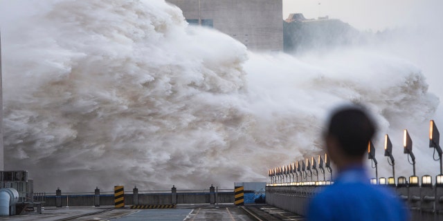 In this photo released by Xinhua News Agency, floodwaters are discharged at the Three Gorges Dam in central China's Hubei province on July 19.