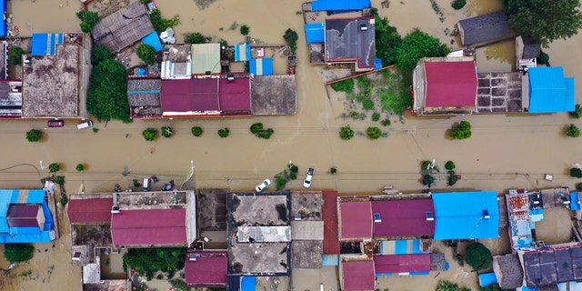 In this photo released by Xinhua News Agency, an aerial photo shows the extent of flooding in Guzhen Town of Lu'an City in eastern China's Anhui Province on July 20.