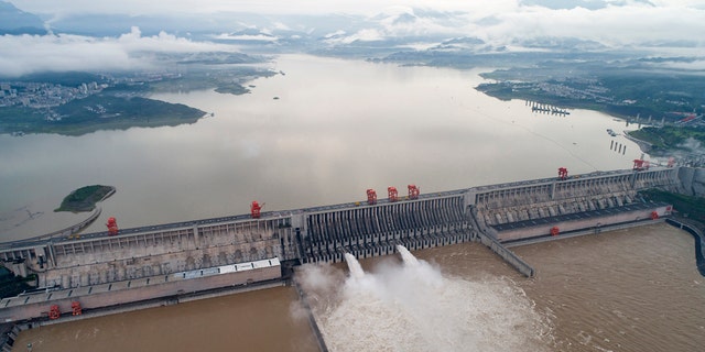 In this photo released by China's Xinhua News Agency, water flows out from sluiceways at the Three Gorges Dam on the Yangtze River near Yichang in central China's Hubei Province, July 17.
