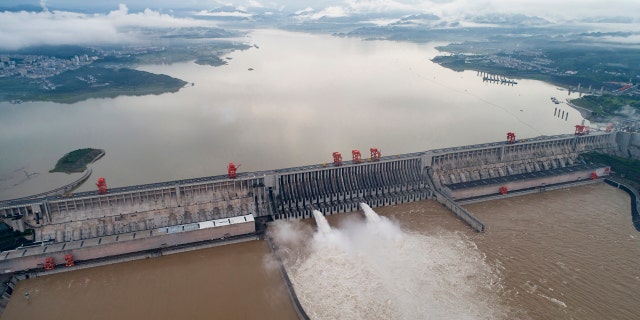 In this photo released by China's Xinhua News Agency, water flows out from sluiceways at the Three Gorges Dam on the Yangtze River near Yichang in central China's Hubei Province, July 17.