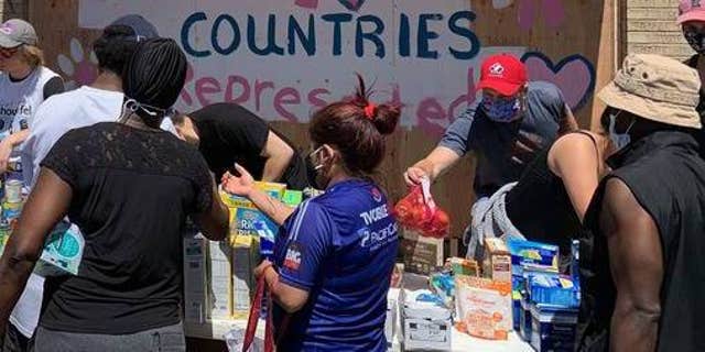 Volunteers give out food and essentials in Minneapolis.