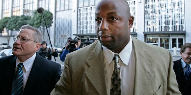 Former NFL football player Dana Stubblefield, front, leaves a federal courthouse with his attorney Mike Armstrong, left, in San Francisco, Friday, Jan. 18, 2008. (AP Photo/Paul Sakuma)