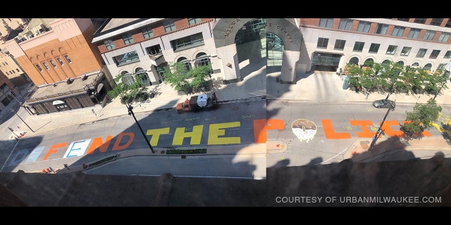 A "Defund the Police" mural outside Milwaukee's City Hall was painted over to read "Defend the Police." The mural was repainted Friday to show its original message.