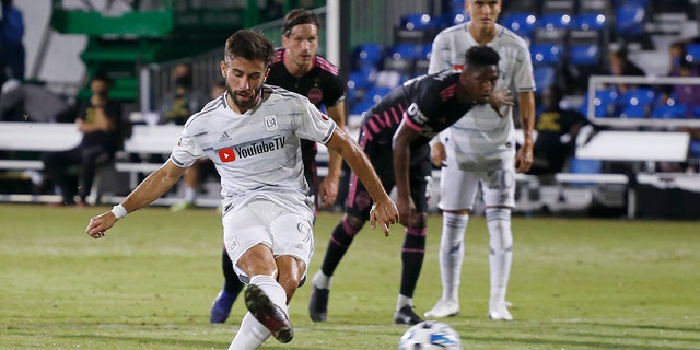 Los Angeles FC forward Diego Rossi (9) scores on a penalty kick against the Seattle Sounders during the first half of an MLS soccer match in Kissimmee, Fla., Monday, July 27, 2020. (AP Photo/Reinhold Matay)