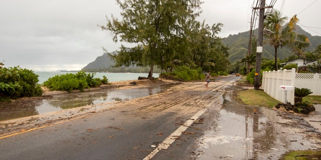 Sand and debris is left on Kamehameha Highway from high surf generated by Hurricane Douglas, Sunday, July 26, 2020, in Hauula, Hawaii.