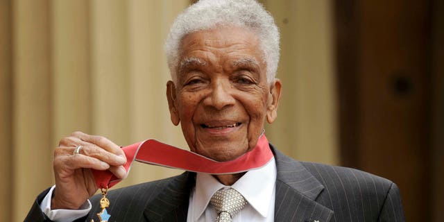 Earl Cameron outside Buckingham Palace after being presented his CBE by Prince Charles, in London. (Anthony Devlin/PA via AP, file)