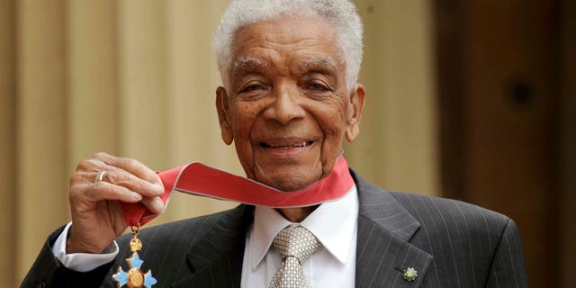 Earl Cameron outside Buckingham Palace after being presented his CBE by Prince Charles, in London. (Anthony Devlin/PA via AP, file)