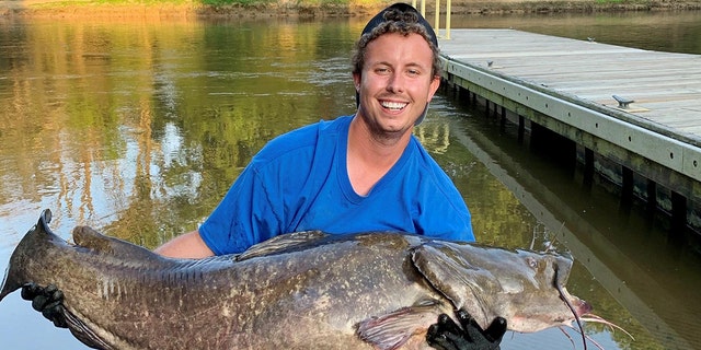 Tyler Barnes with his 78-pound, 14-ounce record-breaking flathead catfish.