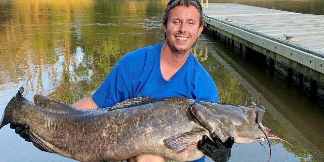 Tyler Barnes with his 78-pound, 14-ounce record-breaking flathead catfish.