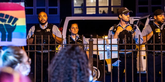Chicago Police Department officers look on as protesters gather outside their precinct on June 19, 2020 in Chicago. (Photo by Natasha Moustache/Getty Images)