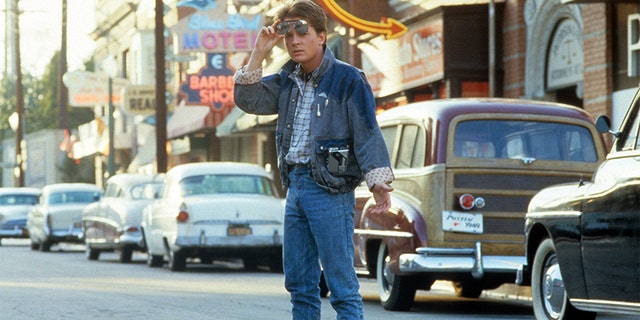 Michael J Fox walking across the street in a scene from the film 'Back To The Future', 1985. 