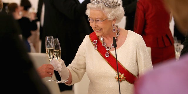 Queen Elizabeth II toasts guests after giving a speech during a State Banquet at the Schloss Bellevue Palace on the second day of a four day State Visit on June 24, 2015 in Berlin, Germany.