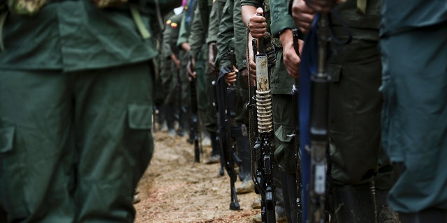 TOPSHOT - Members of the Revolutionary Armed Forces of Colombia (FARC) guerrillas are seen at the "Alfonso Artiaga" Front 29 FARC encampment in a rural area of Policarpa, department of Narino  in southwestern Colombia, on January 17, 2017.  (Photo credit should read LUIS ROBAYO/AFP via Getty Images)