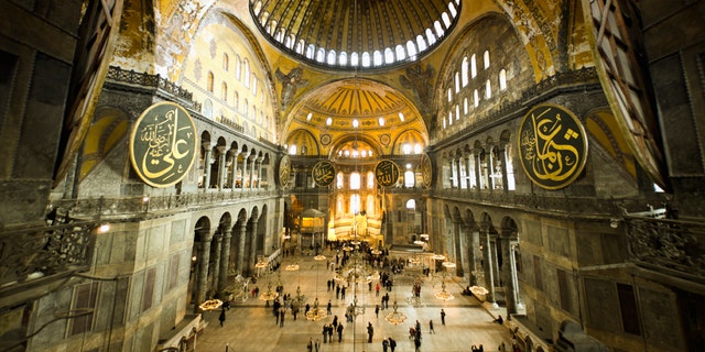 Hagia Sophia (Aya Sofya) indoors captured with fish-eye lens. Warm tone given. Unrecognizable people visible.See more Istanbul
