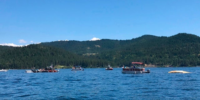 Boaters flag down authorities to a crashed seaplane near Powderhorn Bay on Lake Coeur d'Alene on Sunday, July 5, 2020, south of Coeur d'Alene, Idaho. (Stephanie Hammett/The Spokesman-Review via AP)
