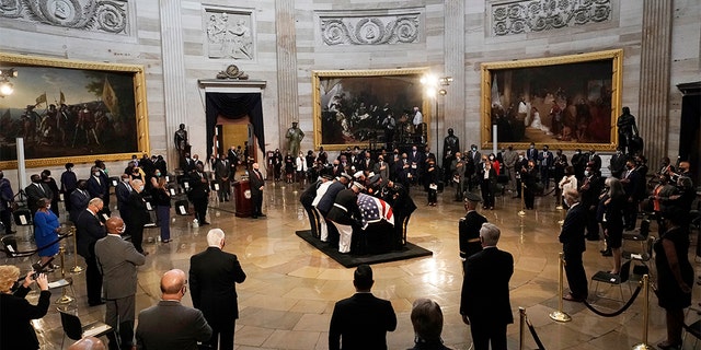 The flag-draped casket of the late Rep. John Lewis, D-Ga.,is placed on the catafalque by a joint services military honor guard, where it will lie in state, Monday, July 27, 2020 at the Capitol in Washington. (AP Photo/J. Scott Applewhite, Pool)