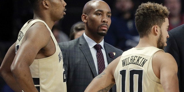 This Nov. 28, 2017 photo shows former Wake Forest assistant coach Jamill Jones, center, during the second half of an NCAA college basketball game in Winston-Salem, N.C. (AP Photo/Chuck Burton)