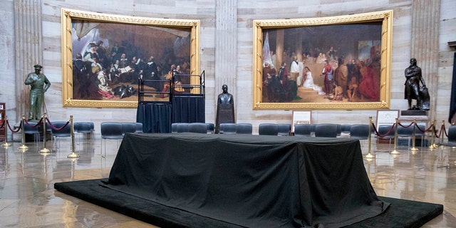 A bust of Martin Luther King, Jr., center, is visible behind the catafalque for the casket of the late Rep. John Lewis, D-Ga., in the center of the U.S. Capitol Rotunda in Washington, Friday, July 24, 2020, before he lies in state Monday. Lewis, who carried the struggle against racial discrimination from Southern battlegrounds of the 1960s to the halls of Congress, died Friday, July 17, 2020. (AP Photo/Andrew Harnik)