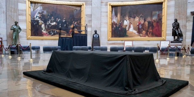 A bust of Martin Luther King, Jr., center, is visible behind the catafalque for the casket of the late Rep. John Lewis, D-Ga., in the center of the U.S. Capitol Rotunda in Washington, Friday, July 24, 2020, before he lies in state Monday. Lewis, who carried the struggle against racial discrimination from Southern battlegrounds of the 1960s to the halls of Congress, died Friday, July 17, 2020. (AP Photo/Andrew Harnik)