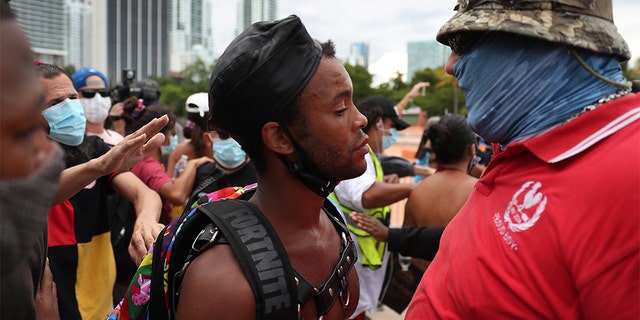 Jonathan Gartrelle (L), participating in a protest against police brutality, confronts a demonstrator taking part in a counter demonstration on June 14, in Miami. (Photo by Joe Raedle/Getty Images)