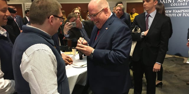 Maryland Gov. Larry Hogan signs the famed wooden eggs during a visit to the New Hampshire Institute of Politics as he mulled a primary challenge against President Trump, in Manchester, N.H. on April 23, 2019