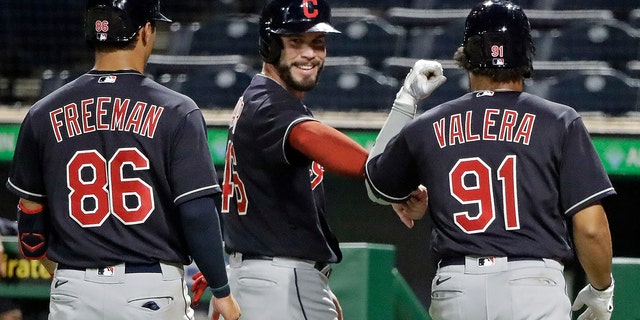 Tyler Freeman (86), Beau Taylor, center, and George Valera celebrate after scoring on a double by Indians' Christian Arroyo off Pittsburgh Pirates relief pitcher Kyle Crick during the eighth inning of an exhibition baseball game in Pittsburgh, Saturday, July 18, 2020. (AP Photo/Gene J. Puskar)