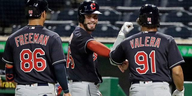 Tyler Freeman (86), Beau Taylor, center, and George Valera celebrate after scoring on a double by Indians' Christian Arroyo off Pittsburgh Pirates relief pitcher Kyle Crick during the eighth inning of an exhibition baseball game in Pittsburgh, Saturday, July 18, 2020. (AP Photo/Gene J. Puskar)