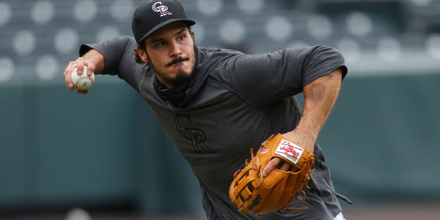 Colorado Rockies third baseman Nolan Arenado takes part in drills during the baseball team's practice Sunday, July 12, 2020, in Denver. (AP Photo/David Zalubowski)