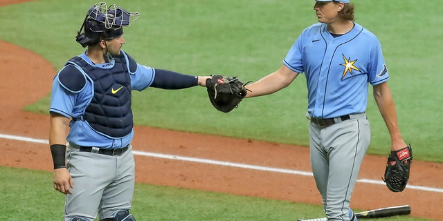 Tampa Bay Rays' Tyler Glasnow, right, bumps fists with catcher Mike Zunino after pitching during baseball practice Tuesday, July 14, 2020, in St. Petersburg, Fla. (AP Photo/Mike Carlson)