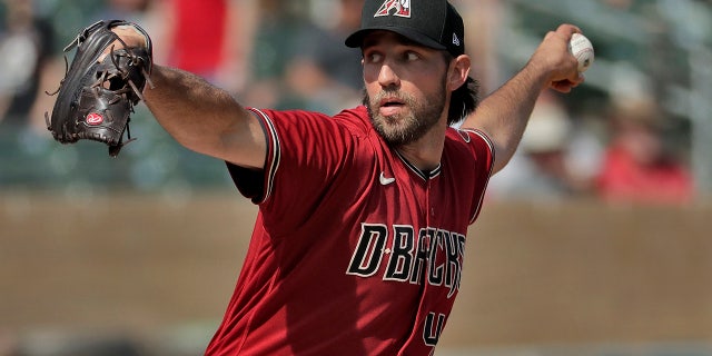 FILE - In this Feb. 27, 2020, file photo, Arizona Diamondbacks pitcher Madison Bumgarner throws during the second inning of spring training baseball game against the Cincinnati Reds in Scottsdale Ariz. (AP Photo/Matt York, File)