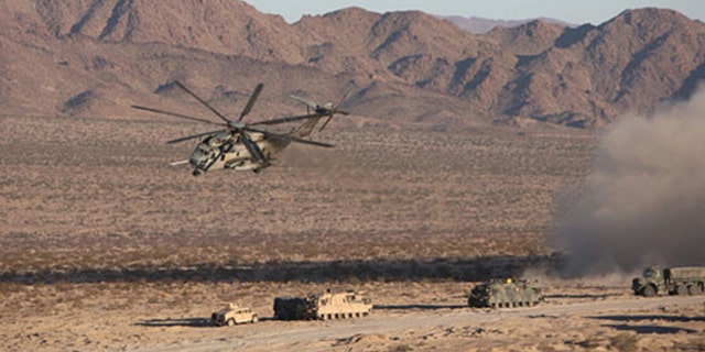 A CH-53E Sea Stallion Helicopter flies in for a simulated medical evacuation during the Tank Mechanized Assault Course aboard Marine Corps Air Ground Combat Center Twenty-nine Palms, California. Dated 2014.