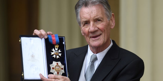 British actor and television presenter Michael Palin poses with his medals after being appointed a Knight Commander of the Order of St Michael and St George (KCMG) during an investiture ceremony at Buckingham Palace in London on June 12, 2019.
