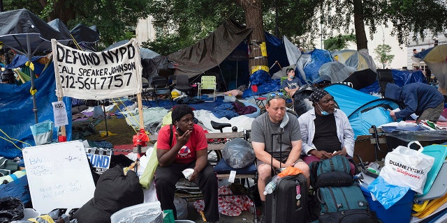 Protesters sit in their encampment, adjacent to City Hall. in New York, Wednesday, July 1, 2020. (AP Photo/Mark Lennihan)
