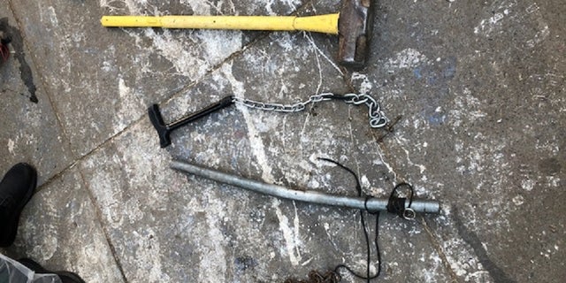 Several weapons, including a sledgehammer, pipe and a chain with a lock were found Thursday during the clean-up of a downtown <a data-cke-saved-href=